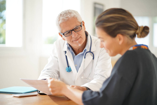 Doctor talking to patient in office - Photo, Image