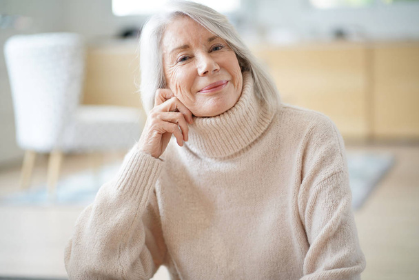 Happy senior woman sitting at home                               - Фото, зображення
