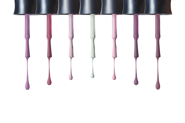  dripping pastel nail polish on brushes isolated on white - Φωτογραφία, εικόνα