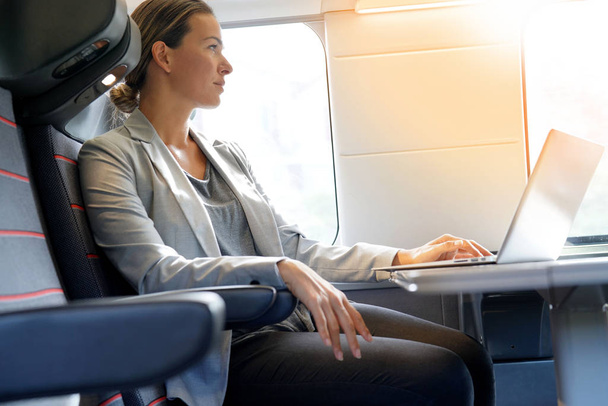 Businesswoman working in first class on a train                                                                                           - Foto, immagini