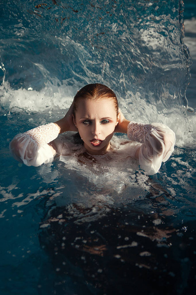 Beautiful model is posing in a swimming pool - Φωτογραφία, εικόνα