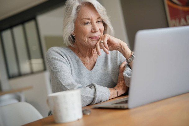 Elderly woman at home with computer                               - Photo, image