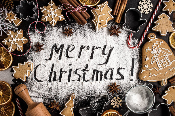 Inscription MERRY CHRISTMAS on powdered sugar  background   - Foto, afbeelding