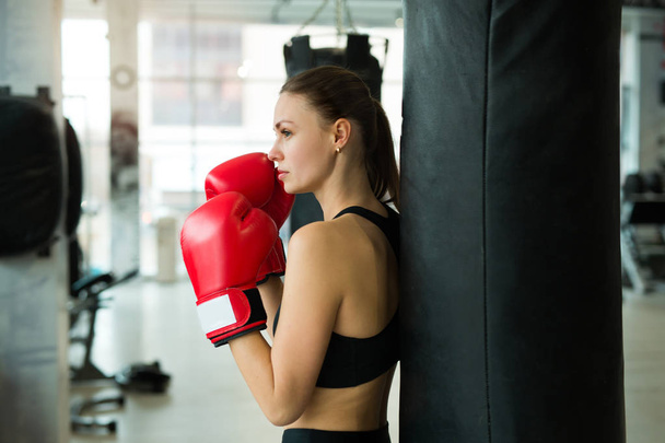 beautiful young girl training in a boxing gym - Photo, Image