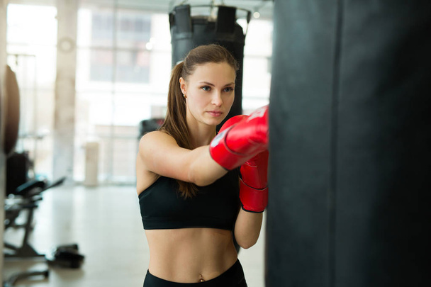 beautiful young girl engaged in training boxing gym - Φωτογραφία, εικόνα