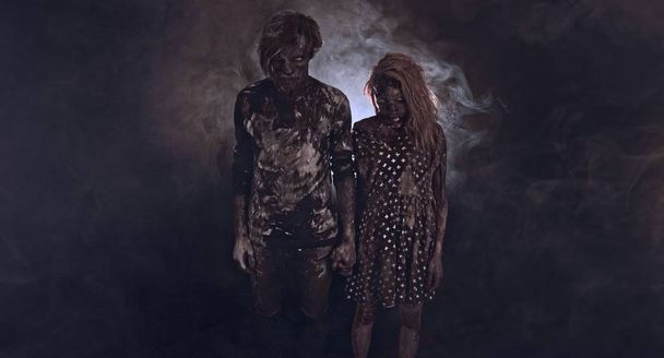 portrait of zombies together against dark misty background - Photo, image