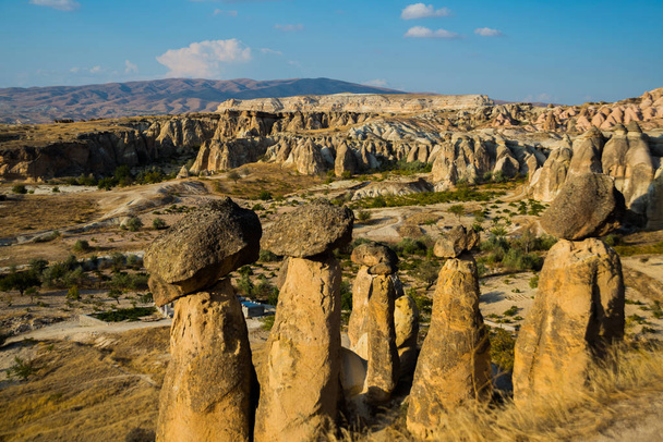 Fairy chimneys view near Cavusin Town in Cappadocia. Cave house of Fairy Chimneys rocks mushroom in Pasabag, Monks Valley, Anatolia, Turkey. - 写真・画像