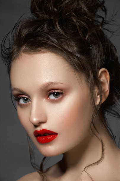 Makeup, cosmetics. Beauty young woman portrait. Beautiful model girl with beauty makeup, red lips, perfect fresh skin. Attractive lady with green eyes. Youth and Skin Care Concept - Photo, Image