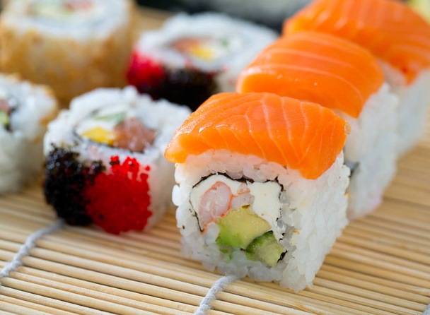 Appetizing sushi assortment on chalkboard - Фото, изображение