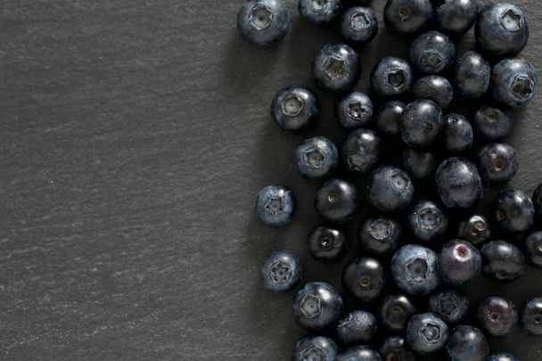 blueberries on stone board - Foto, imagen