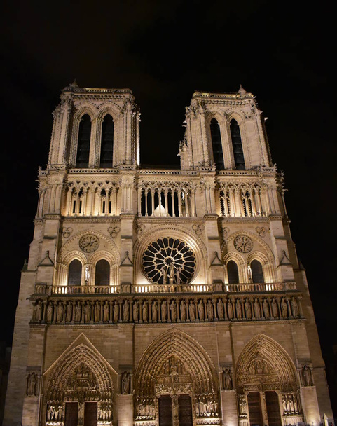 Cattedrale di Notre Dame a mezzanotte. Facciata, torri, rosone, archi e statue. Parigi, Francia
. - Foto, immagini