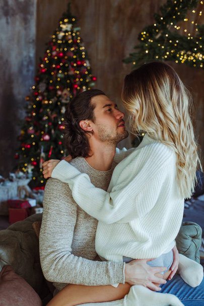 Couple celebrating Christmas at home - Фото, изображение