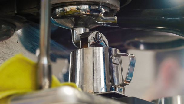 An espresso pouring from the coffee machine - Photo, Image