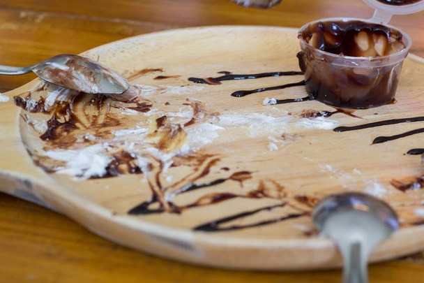 Abstract after eating dessert banana on the wooden table. - Photo, Image