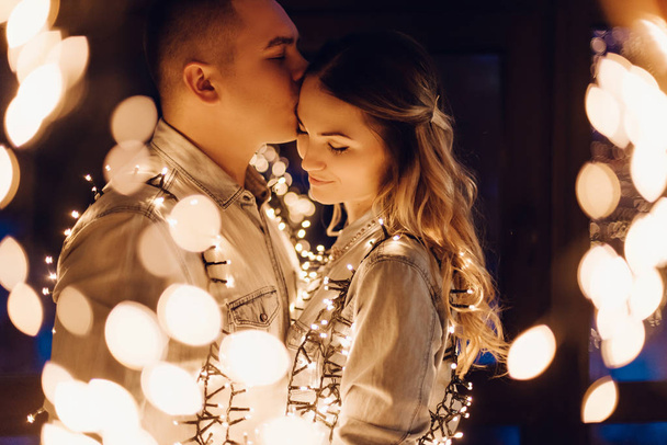 couple in love hugging in dark among multitude of lights - Valokuva, kuva