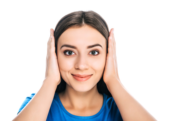 portrait of attractive smiling woman covering ears with hands isolated on white - Φωτογραφία, εικόνα