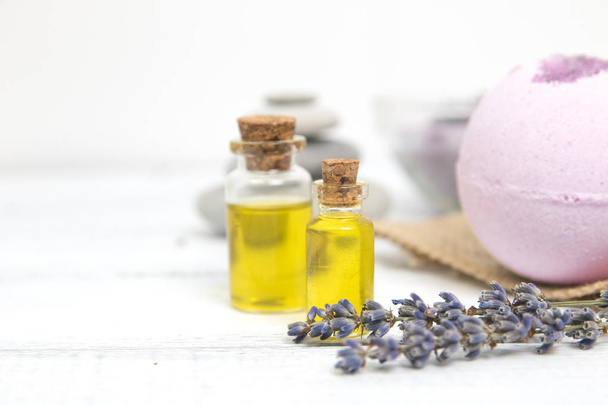 lavender oil in a glass bottle on a background of fresh flowers. Horizontal close-up - Фото, изображение
