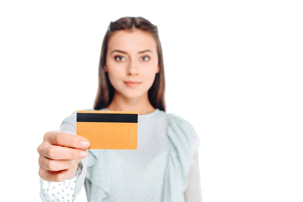portrait of young woman showing credit card isolated on white - Foto, imagen