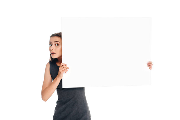 portrait of shocked young woman holding blank banner isolated on white - Fotoğraf, Görsel