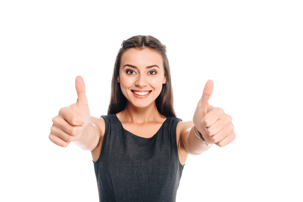 portrait of smiling woman in stylish black dress showing thumbs up isolated on white - Fotó, kép