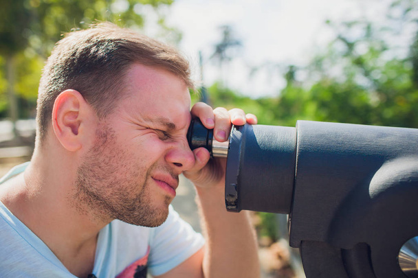 young man Binocular against observation deck view. - Fotografie, Obrázek
