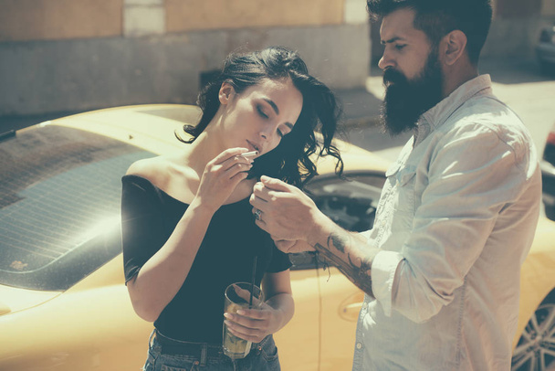 Set the date off nicely. Couple in love date on street. Romantic couple have cocktail date. Cute woman and bearded man smoke and drink outdoor. Smoking and alcohol addiction. Bad habit and addiction - Φωτογραφία, εικόνα