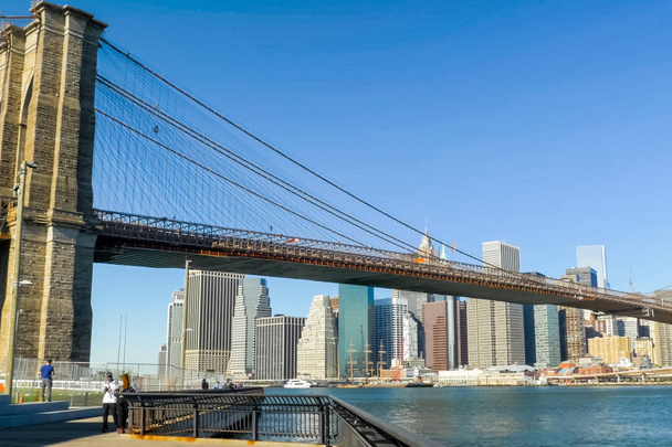 New York, USA - June 20, 2015: The Brooklyn Bridge. Walk on the bridge. Walking through the streets of New York, Manhattan. The life of New York in the afternoon. Streets and city buildings. - Photo, Image