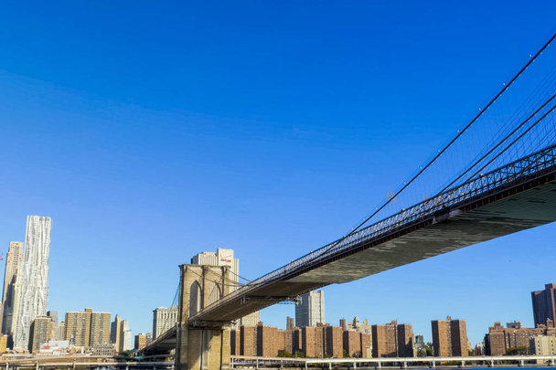 New York, USA - June 20, 2015: The Brooklyn Bridge. Walk on the bridge. Walking through the streets of New York, Manhattan. The life of New York in the afternoon. Streets and city buildings. - 写真・画像