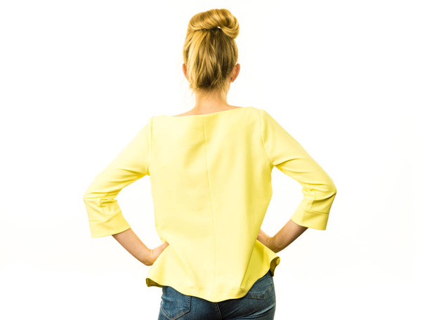 Adult woman presenting her casual beautiful outfit, long sleeved yellow top from back. - Valokuva, kuva