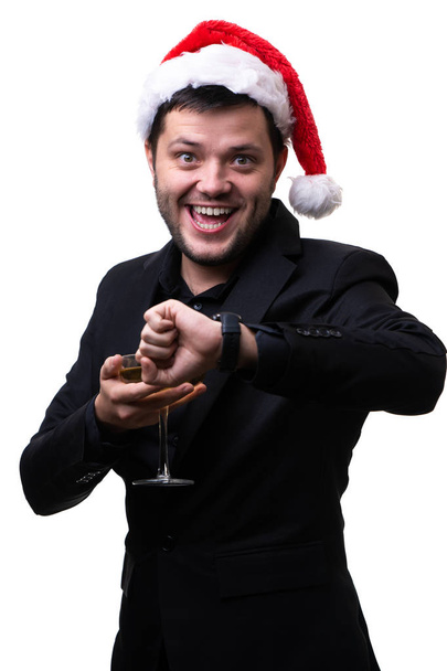 Image of happy man in santa hat with champagne glass and clock on hand - Zdjęcie, obraz