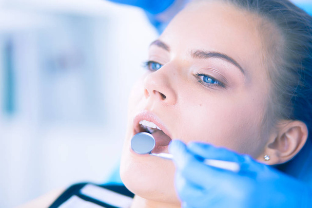 Young Female patient with open mouth examining dental inspection at dentist office. - Fotoğraf, Görsel