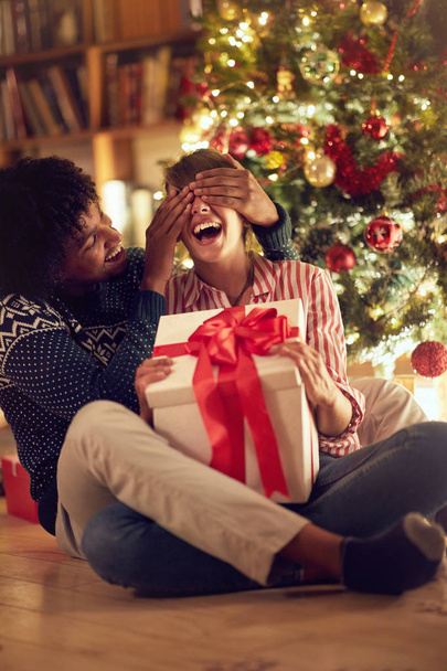 romantic surprise for Christmas  young male and female with present - Foto, imagen