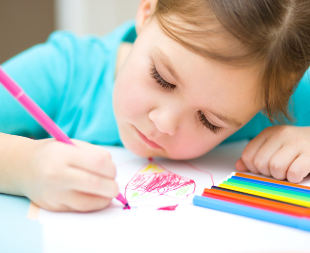 Cute cheerful child drawing using felt-tip pen - Fotó, kép