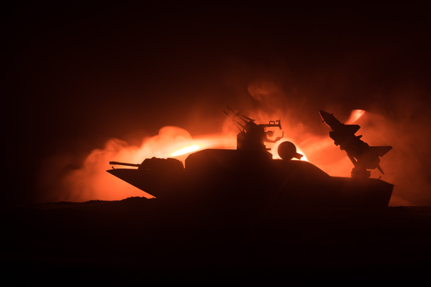 Sea battle scene. Silhouette of military war ship on dark foggy toned sky background. Dramatic war scene with Explosion and fire as decoration. Selective focus - Photo, Image