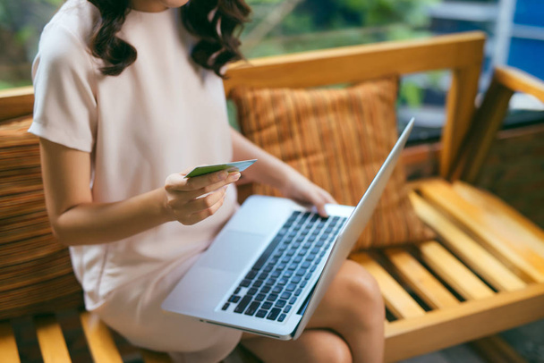 Businesswoman doing online shopping through laptop and credit card - Fotoğraf, Görsel