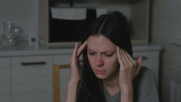 Woman with headache in the kitchen at night. Insomnia and depression. - Filmagem, Vídeo