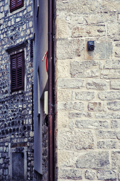 CCTV security camera on ancient stone wall - Valokuva, kuva
