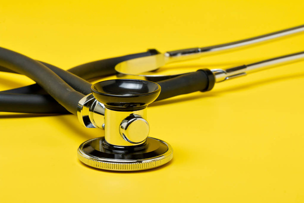 Stethoscope, close-up isolated with yellow background - Photo, Image