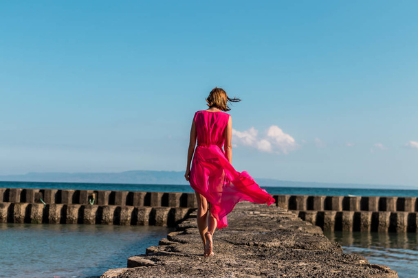 Young woman on a tropical beach of Bali island. Indonesia. - Фото, зображення