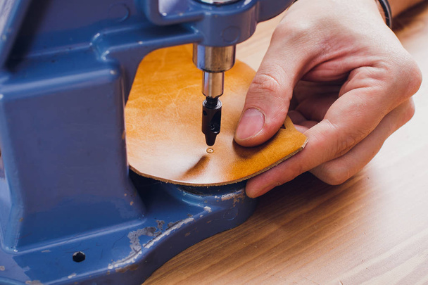 leather craftsman working making products at table in workshop studio. - Foto, Imagem