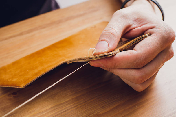 leather craftsman working making products at table in workshop studio. - Φωτογραφία, εικόνα
