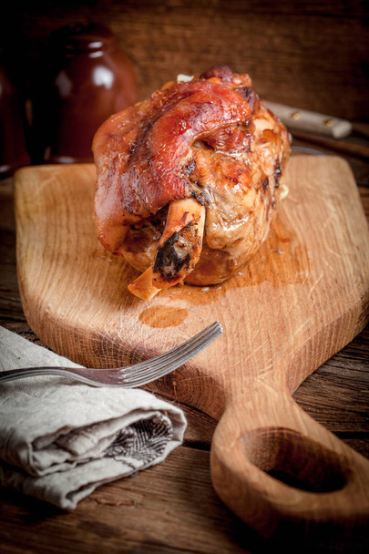 Roast pork knuckle on a wooden board. Selective focus. - Fotó, kép