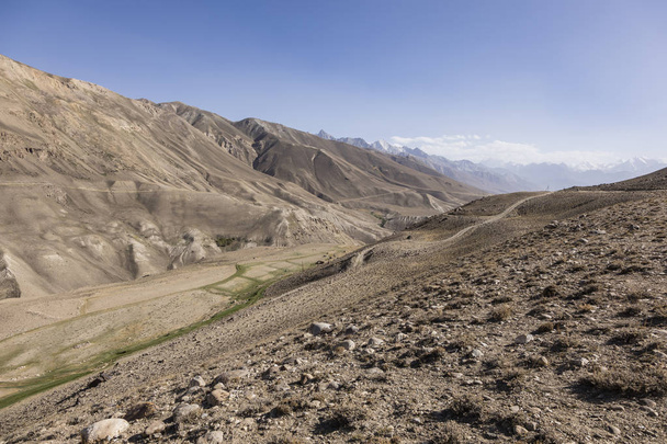 Pamir Highway v pouštní krajině Pamírových hor v Tádžikistánu. Afghánistán je nalevo - Fotografie, Obrázek