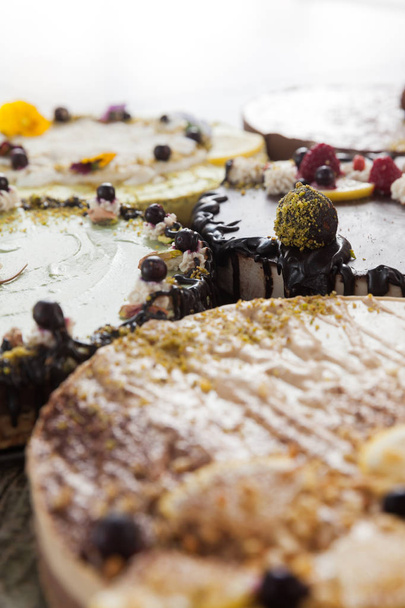 Delicious raw vegan cakes with lovely decorations on it. - Foto, afbeelding