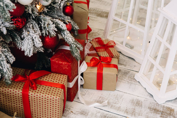 beautiful Christmas decorations and gifts under the Christmas tree - Фото, зображення