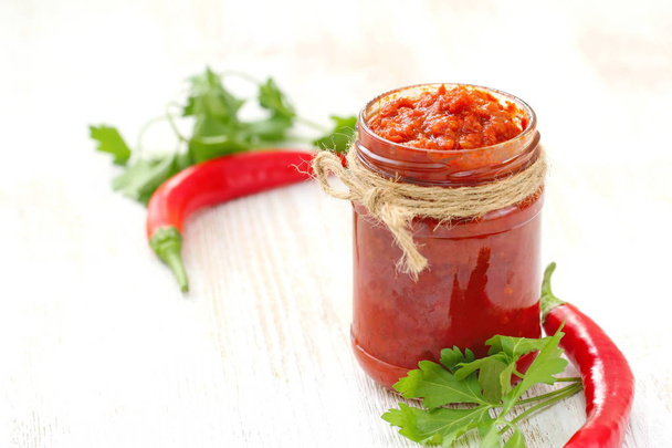 Cibo vegano. Deliziosa salsa fatta in casa a base di verdure. Salsa di pomodoro piccante con peperoncino e aglio
 - Foto, immagini