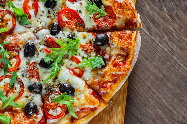 Pizza Margherita or Margarita with Mozzarella cheese, tomato, olive. Italian pizza on wooden background - Φωτογραφία, εικόνα