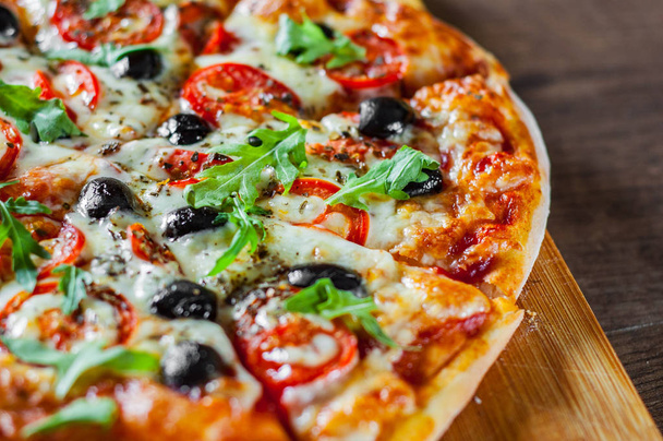 Pizza Margherita or Margarita with Mozzarella cheese, tomato, olive. Italian pizza on wooden background - Φωτογραφία, εικόνα