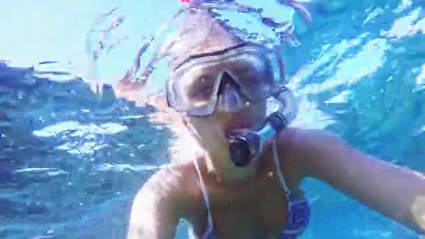 Underwater selfie, woman dive in snorkeling diving mask and snorkel in the clear blue sea water. - Footage, Video