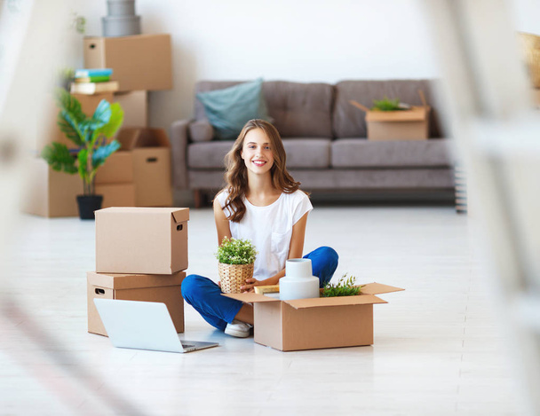 happy young girl with boxes moves to new apartmen - Photo, Image